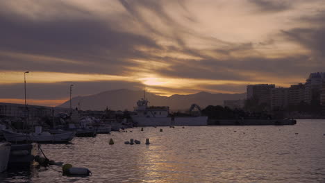 marbella fishing port at sunset, fishing boats bobbing up and down in the harbor