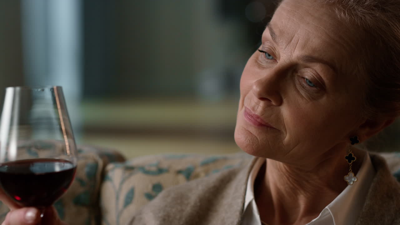 Calm senior woman relaxing with alcohol drink