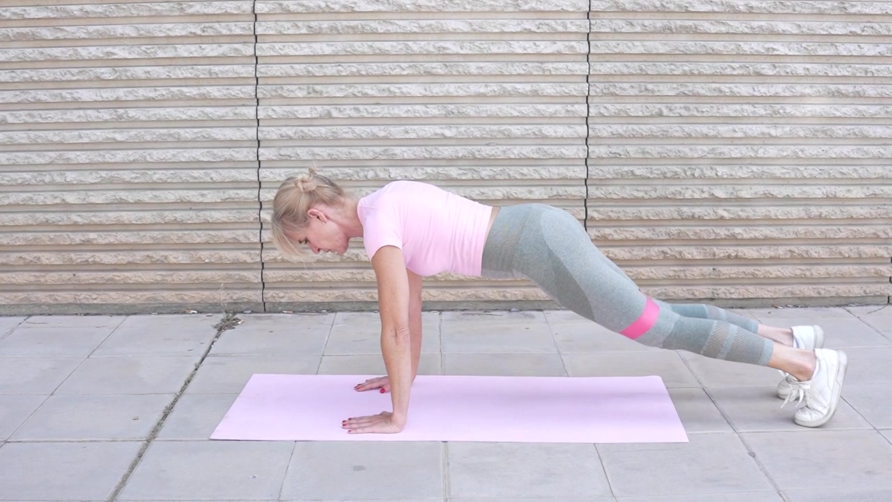 A woman engages in a resistance band workout to enhance the strength of her lower body