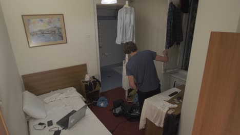 Young-man-looks-out-dorm-room-window