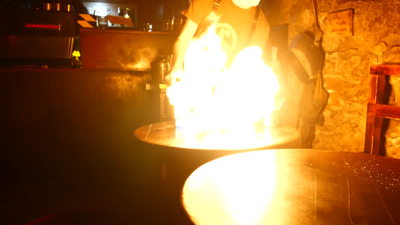 Barista throwing flames making creme brûlée coffee with flamethrower underground in mine manufacturer, Lviv Ukraine Lvivska