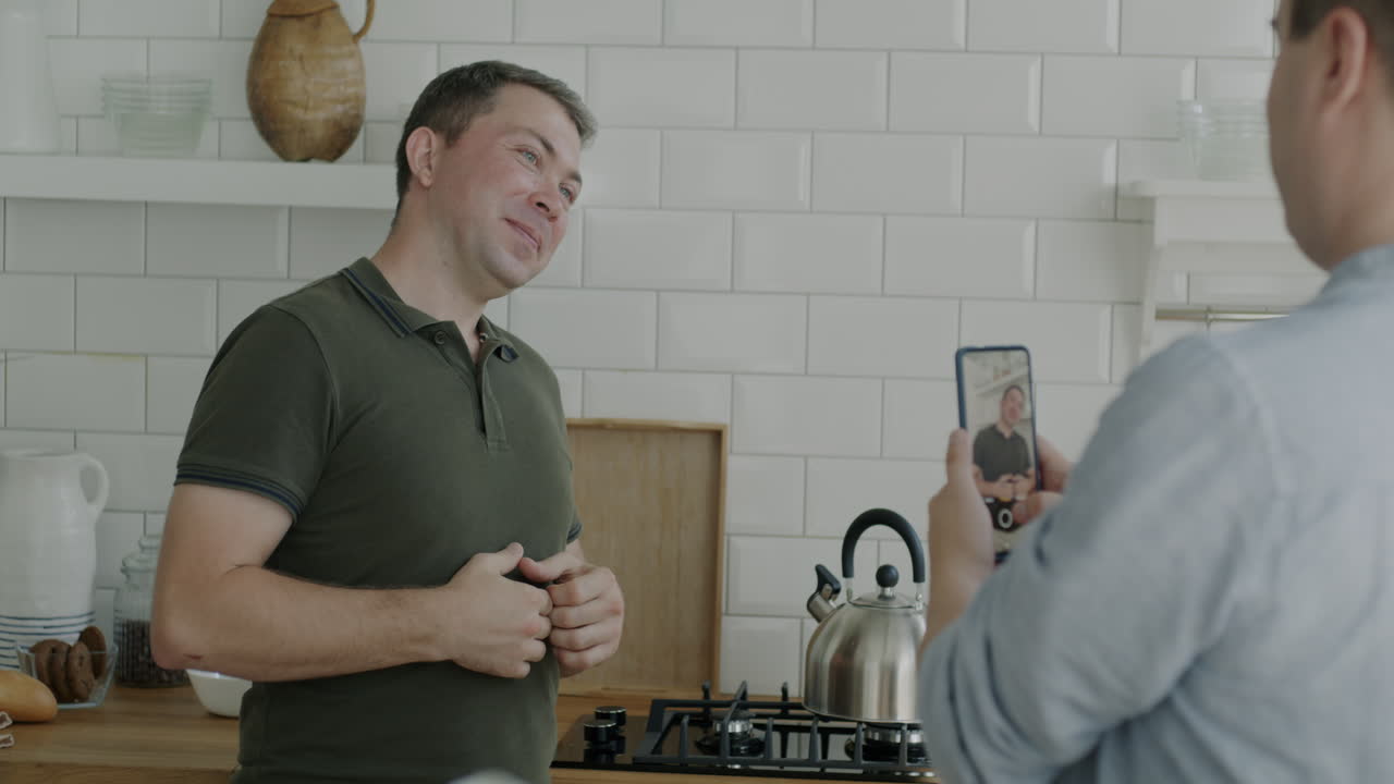 Man taking video call in kitchen