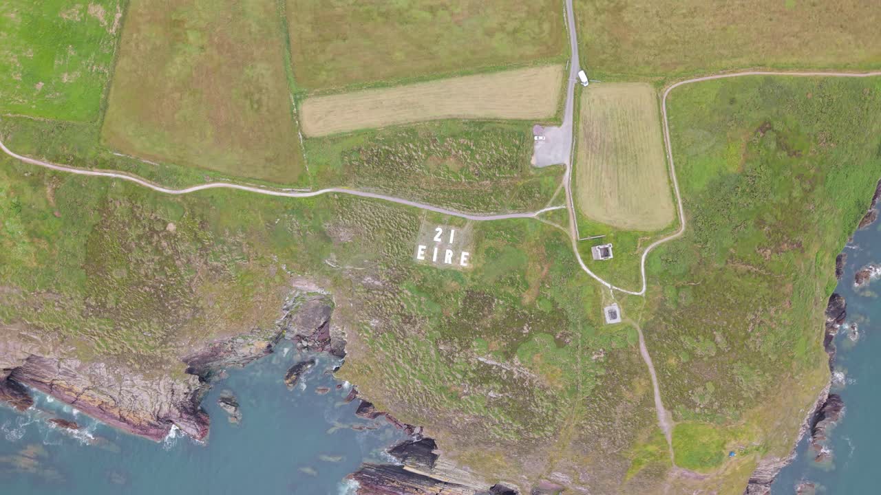 Overhead View Of EIRE 21 Sign On The Coastal Headland In Creaken, County Cork, Ireland. - aerial shot