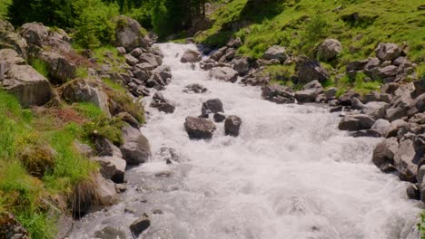 revealing shot of whitewater in river schächen with staubifall in distance