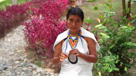 indigenous woman from the sierra nevada of colombia making traditional weavings