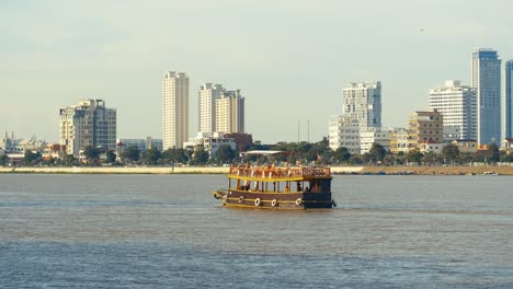 boat on the river with city skyline in the background