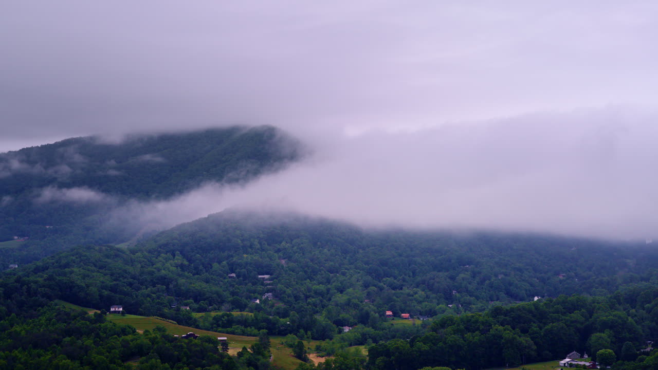 Aerial shot gliding over a dreamy, mist-filled Smoky Mountain landscape