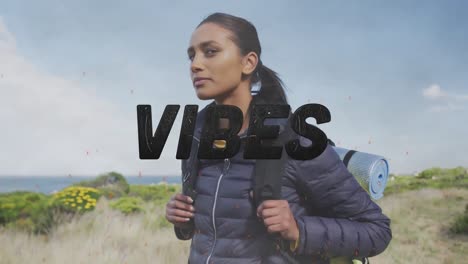 animación de la palabra vibra escrita en negro sobre una mujer feliz caminando en las montañas
