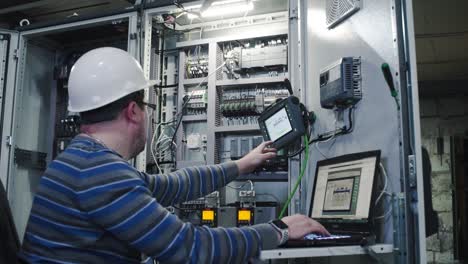 industrial technician working on control panel