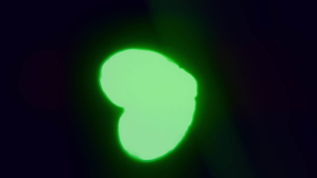 Green energy heart shapes on a dark background