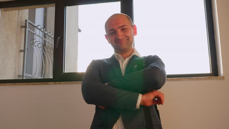 cheerful boss looking at camera and smiling standing on stairs