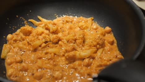 no meat indian curry sauteed in an iron pan