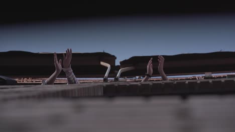 people clapping on a rooftop