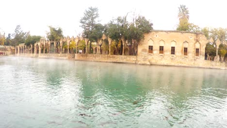 fog spreads under pool of sacred fish panorama urfa