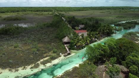 Tilt-down-drone-shot-of-the-river-of-Los-Rapidos-de-Bacalar