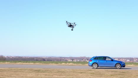 follow shot of a drone and a car, film shoot