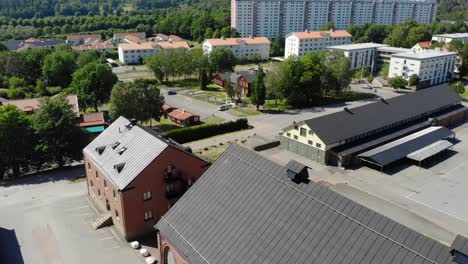 Aerial view of large buildings, green trees and small streets in suburban area