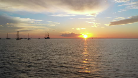 aerial - yachts at anchorage on peaceful afternoon with a beautiful sunset background. travel by boat - adventure and freedom concept.