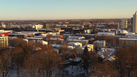 drone shot over snowy roof tops of karlova district towards to snail tower tigu torn