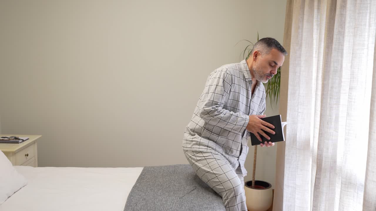 A man in pajamas in a bedroom