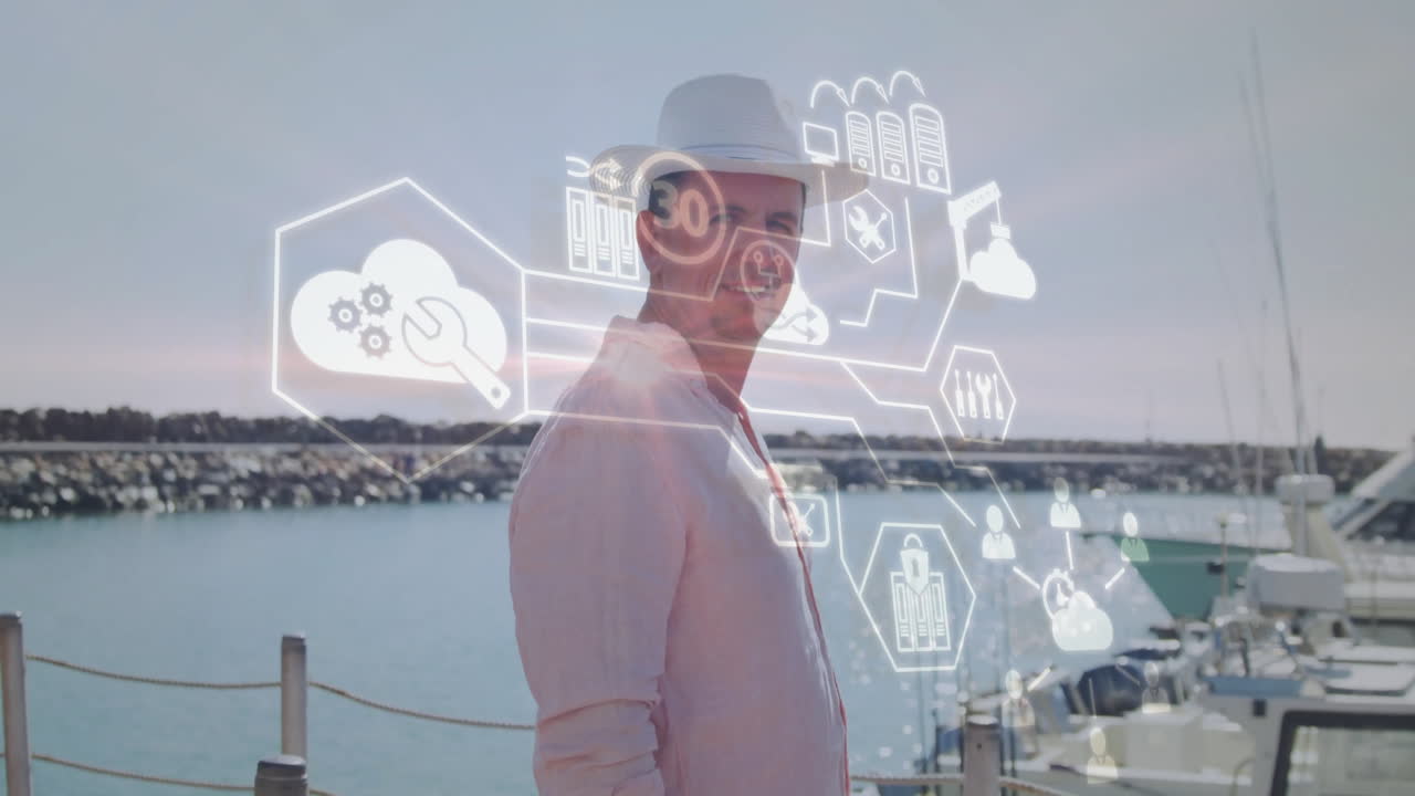 At marina, man wearing hat with animation of technology icons overlaying