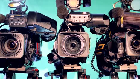 zoomed-out image of three professional camcorders