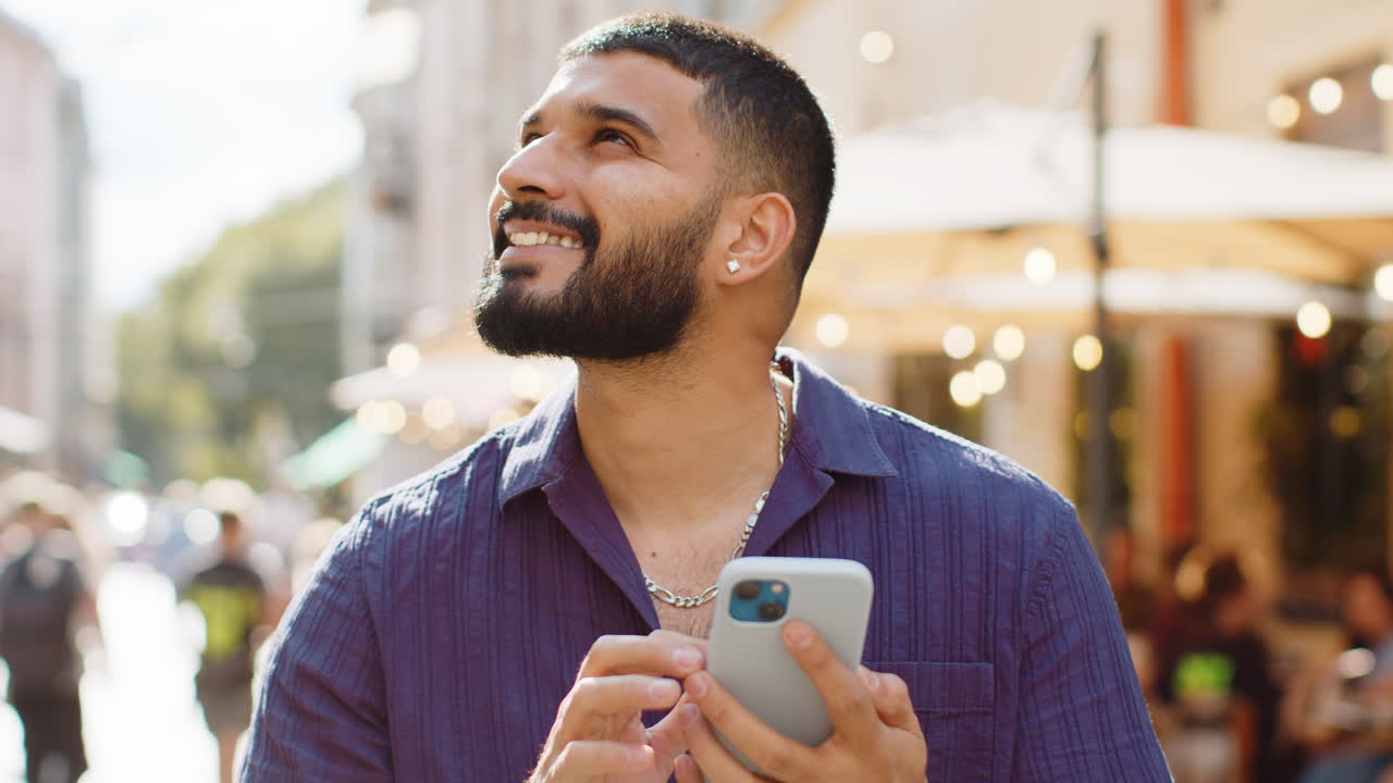 Indian man use smartphone typing text messages browsing internet ...
