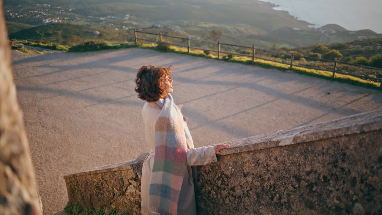 Tourist looking panoramic view from historical place stairs. Relaxed woman