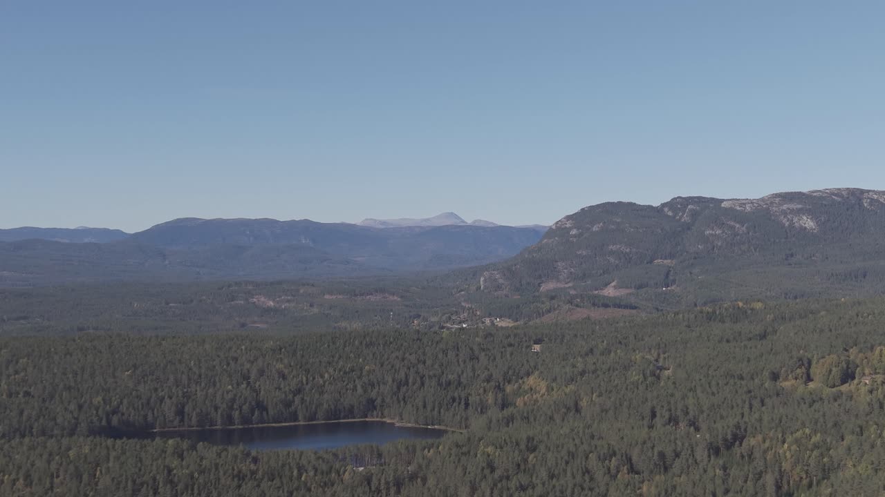 Landscape of Telemark region in Norway with a visible peak of mount Gaustatoppen i a far. Drone footage