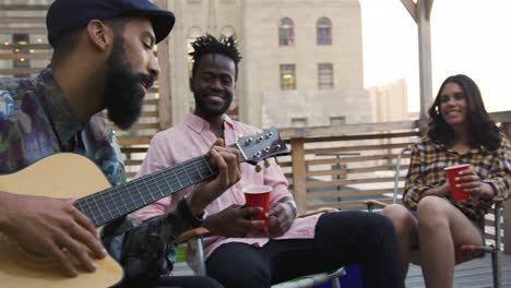 young adult friends hanging out on a rooftop