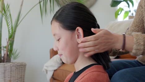 Asian,-mother-and-hands-tie-hair-of-adolescent