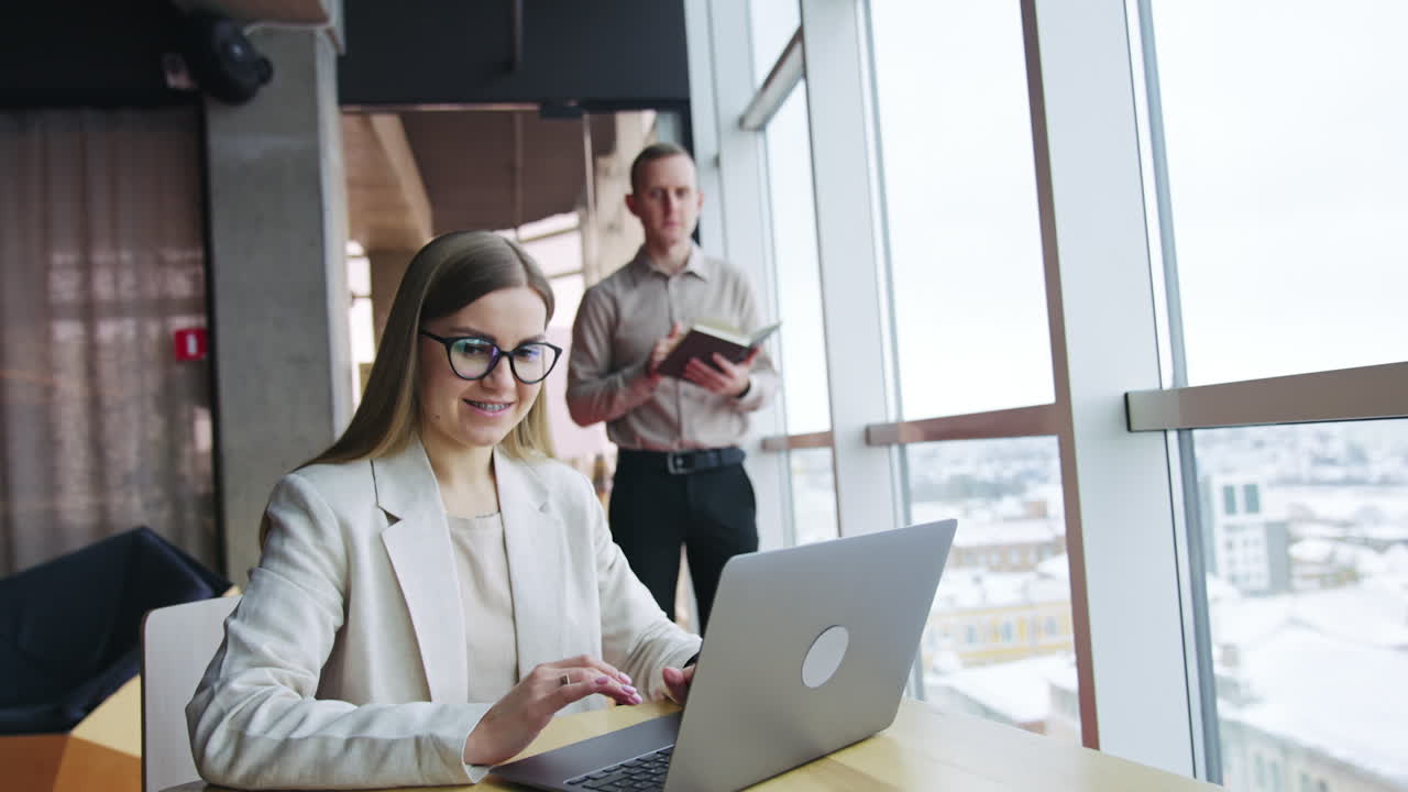 Empresaria y empresario trabajando en una oficina