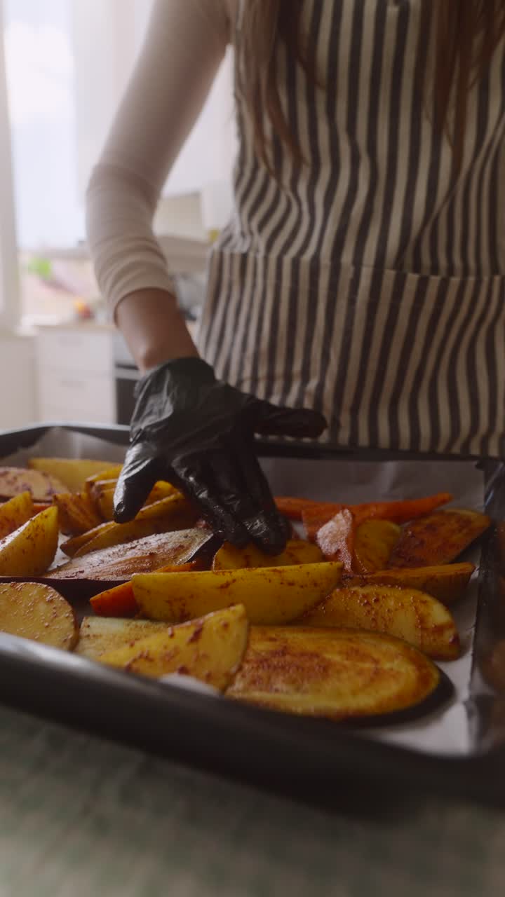 Woman preparing roasted vegetables in the kitchen