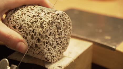 close up of cutting concrete - geo polymer with string saw - shot from workroom in slow motion