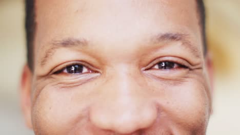 Portrait-of-african-american-man-smiling-in-living-room