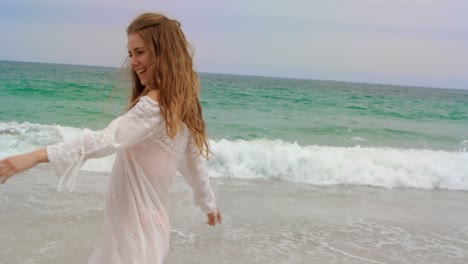 Happy-Caucasian-woman-dancing-at-beach-on-a-sunny-day-4k
