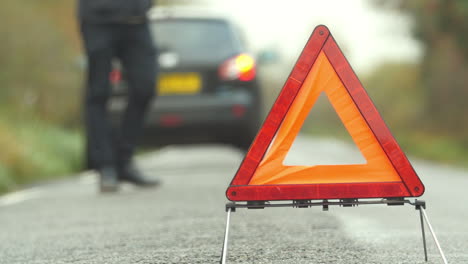 driver broken down calling recovery service on mobile phone