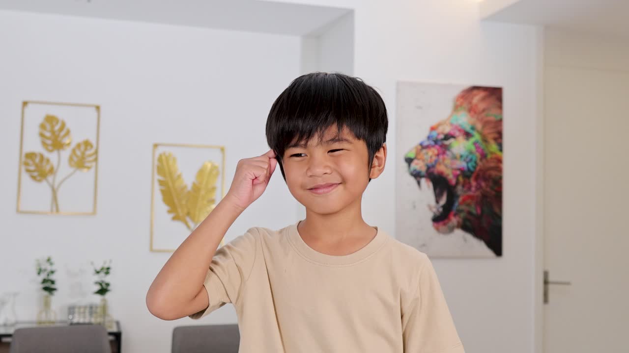 Young boy acts out thinking and idea gesture, smiling in brightly lit, modern home interior