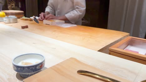 chef skillfully prepares and serves sushi nigiri