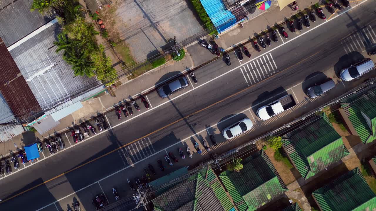 A road through a Town on koh chang, thailand, showcasing hotels, Restaurants and bars. Breathtaking aerial view flight rotation to left drone