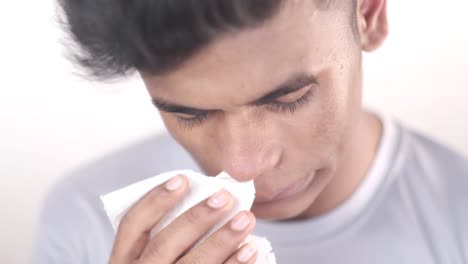 man blowing his nose