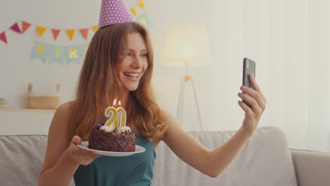 woman celebrating her 20th birthday via video call