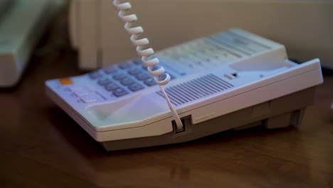 person using a corded telephone