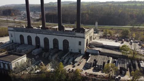 Aerial-shot-of-an-old-factory-along-the-Mohawk-River-in-Upstate,-NY