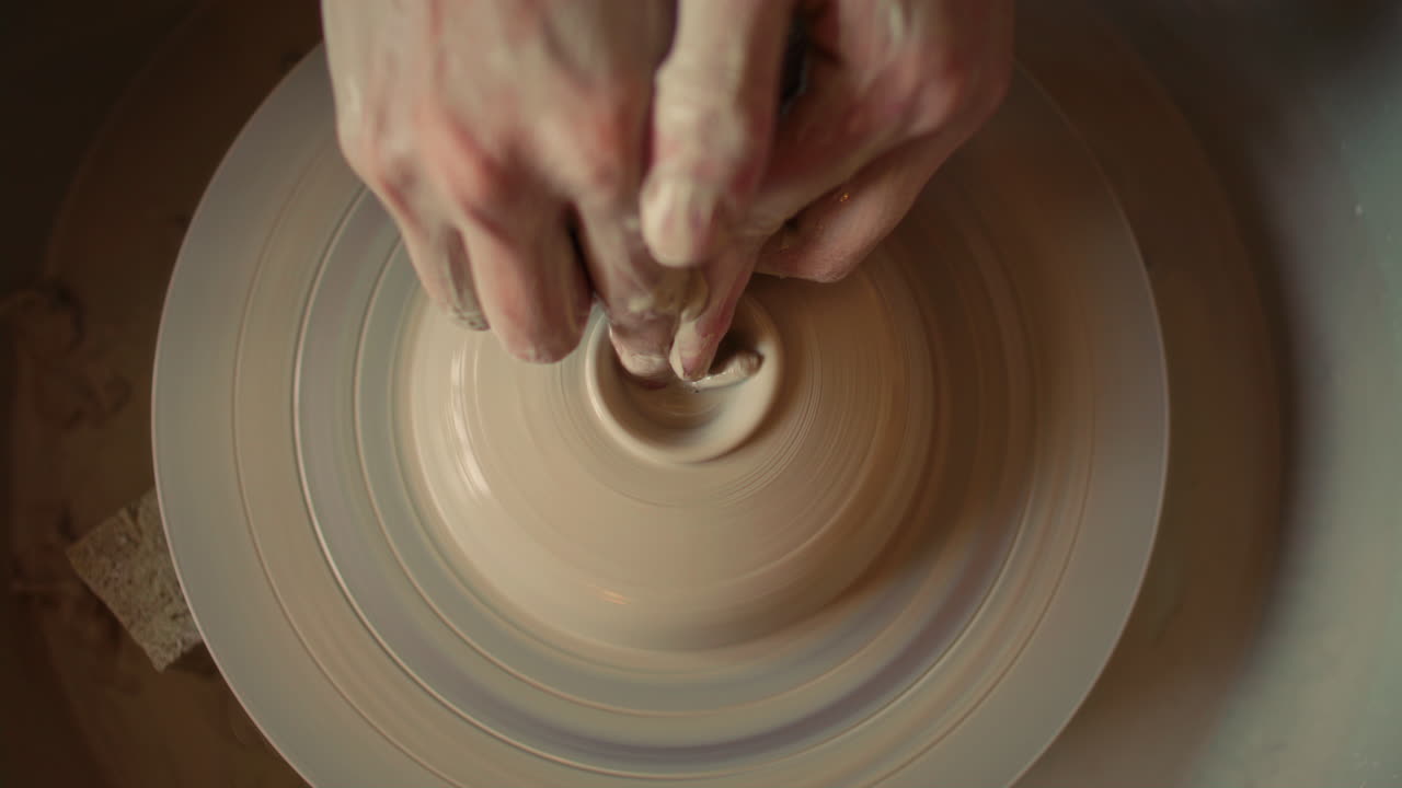 Close Up of Opening Clay Center with Fingers on Spinning Pottery Wheel