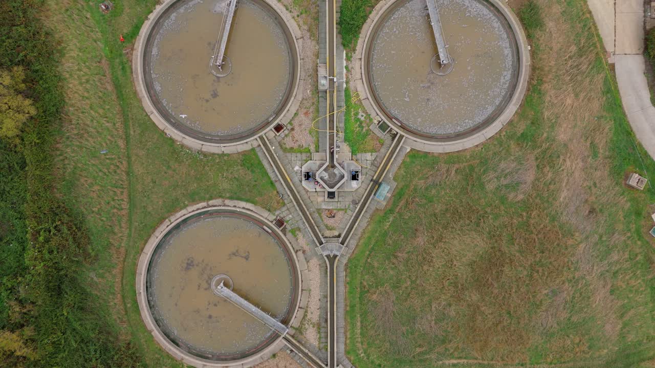 Top-down aerial drone sweep of a sewage treatment plant, highlighting waste processing, filtration, and clean water production for public use