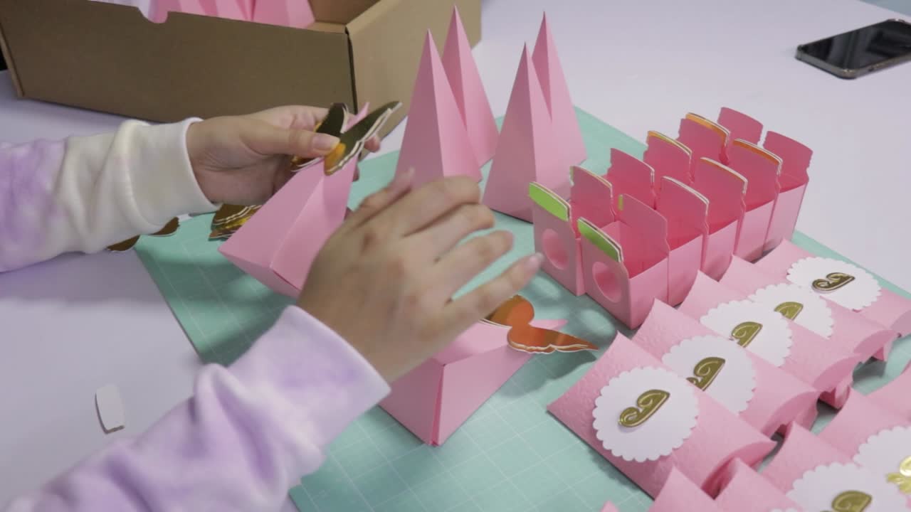 Woman creating handmade gift boxes, paper crafts decoration