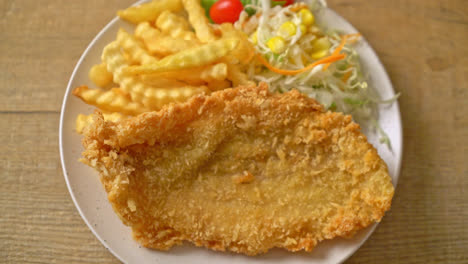 fried fish fillet and potatoes chips with mini salad