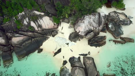 mahe seychelles baie lazare people on the beach and rock boulders 1