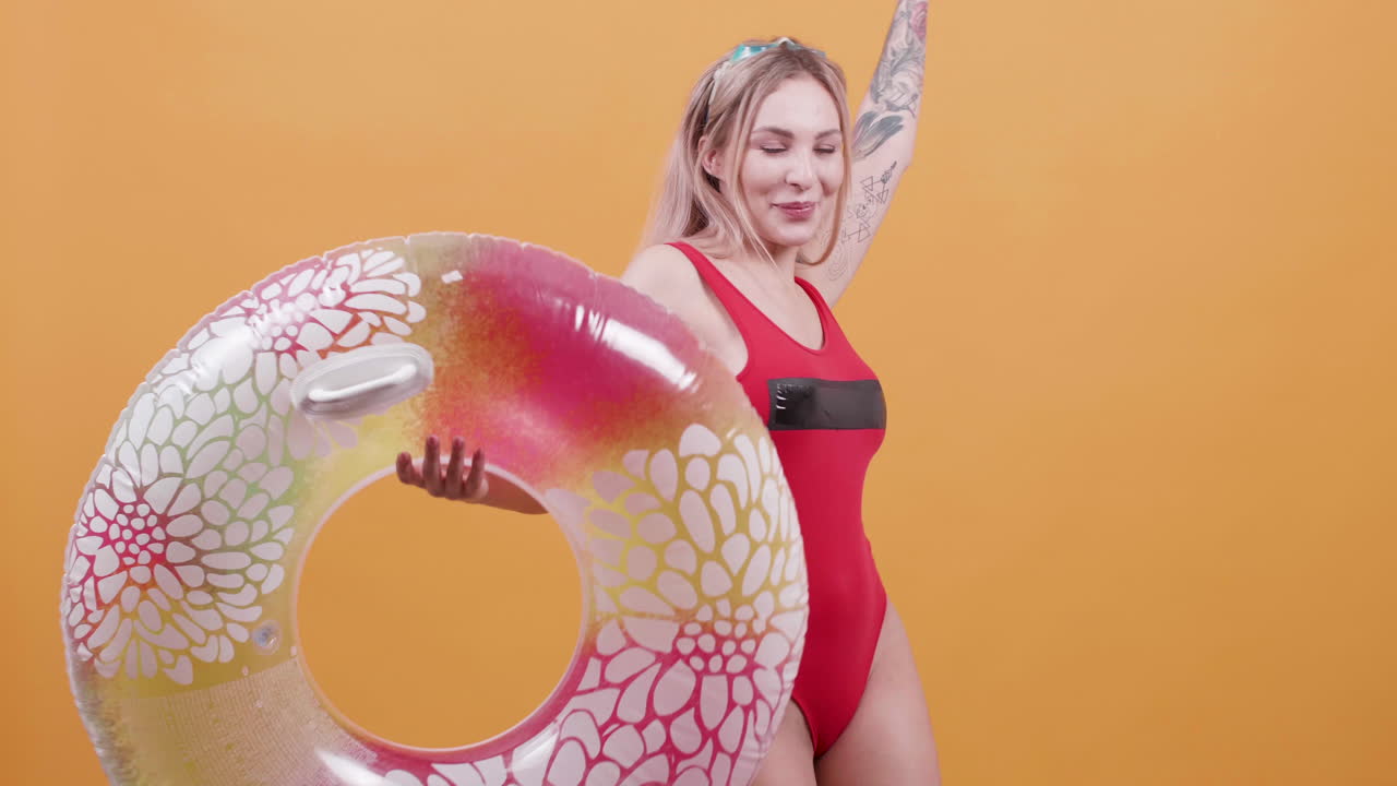 Woman in swimsuit holding swim ring